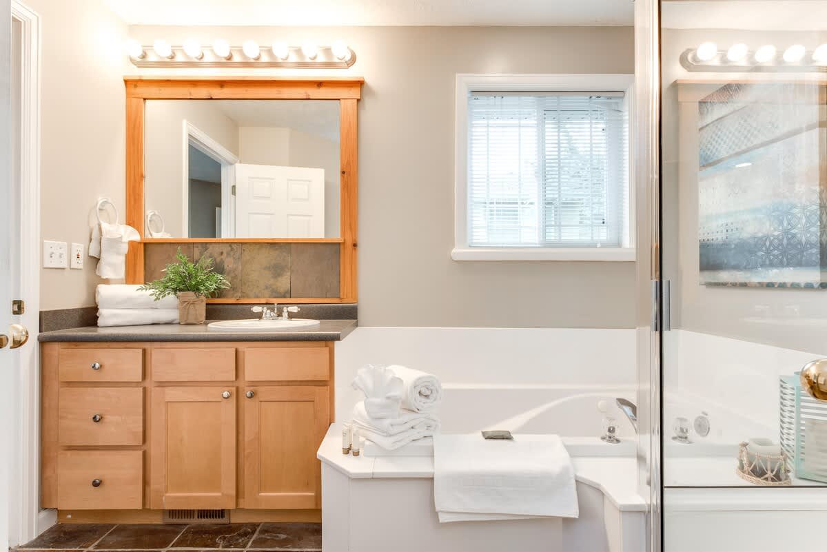 Master bathroom with tub and shower in Union Woods home