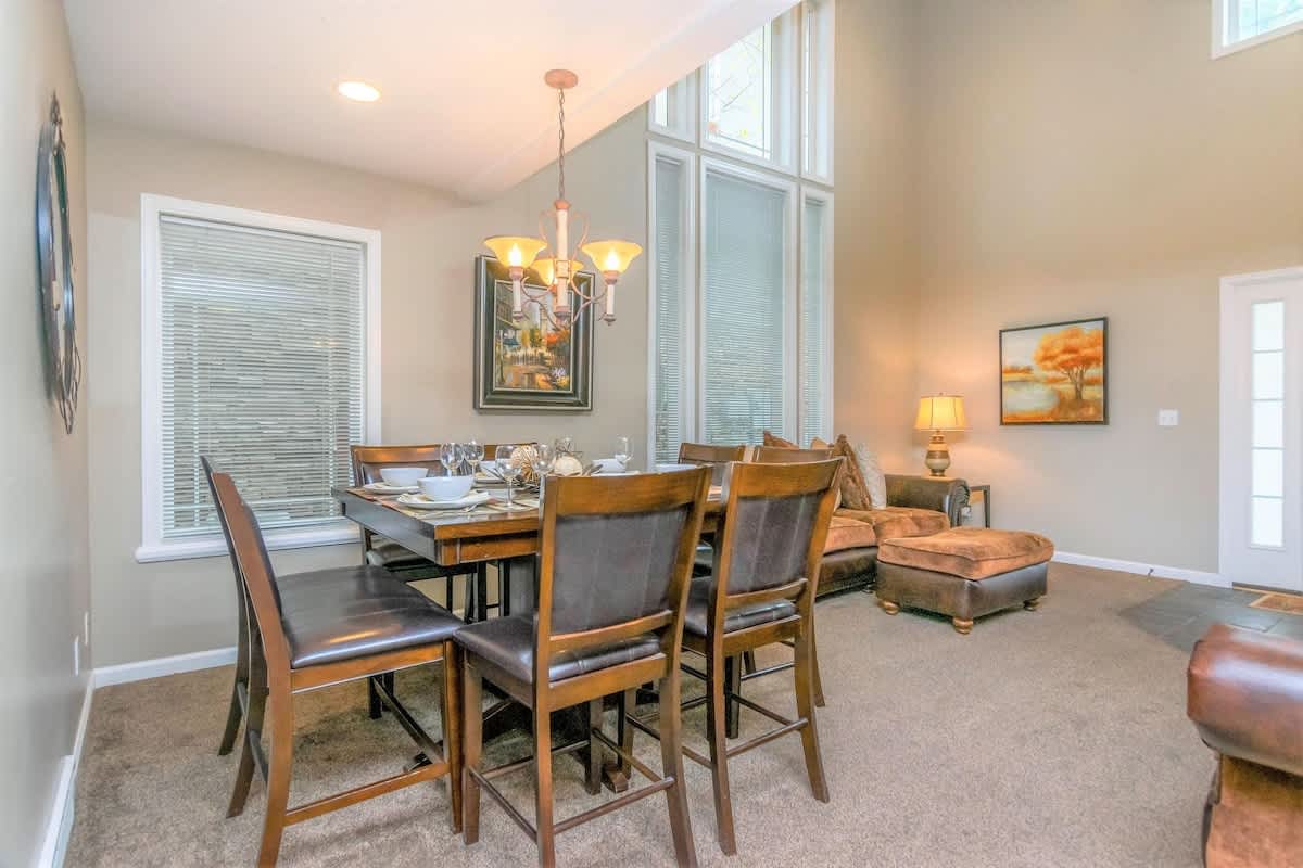 Open concept family room with dining table in union Spruces home