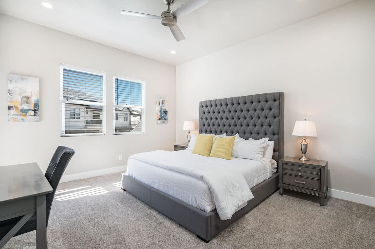 Bedroom 3 wtih gorgeous king tufted bed and desk