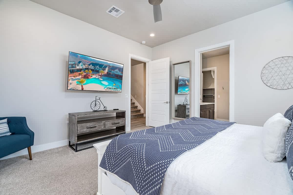 Master bedroom on main level with TV and bathroom