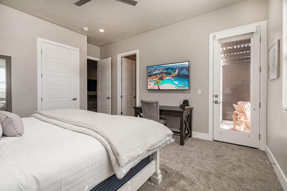 Master bedroom with desk and balcony access