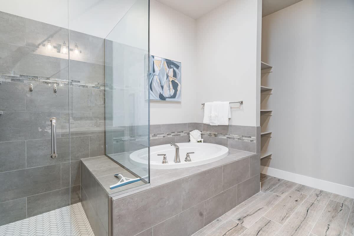 Gorgeous master bathroom with tub and fabulous glass shower 
