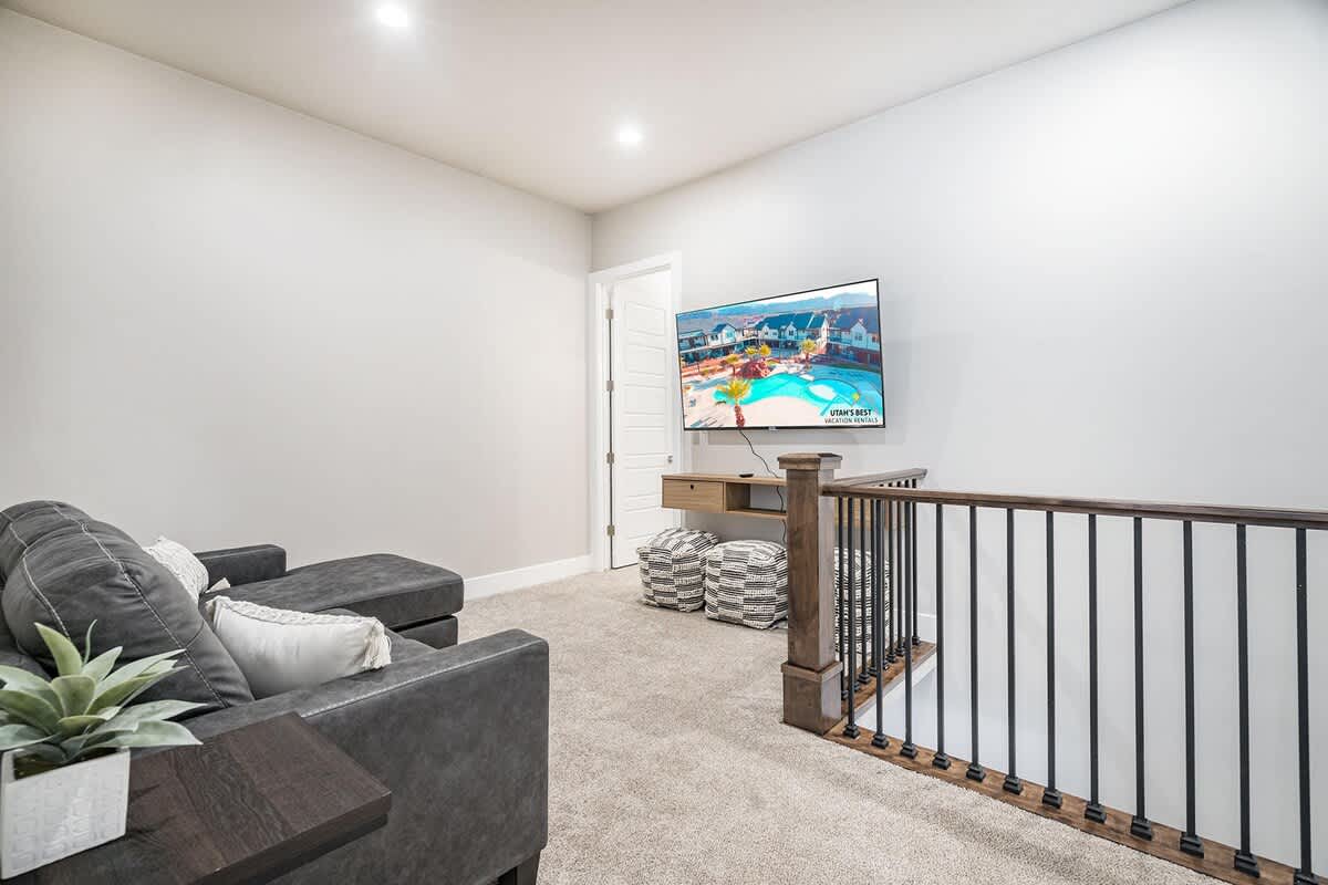Upstairs small family room loft area with TV and sofa sleeper