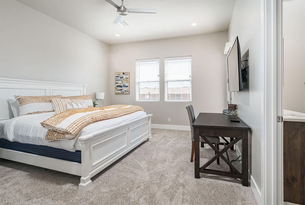 House #51 master bedroom with king bed, desk and balcony