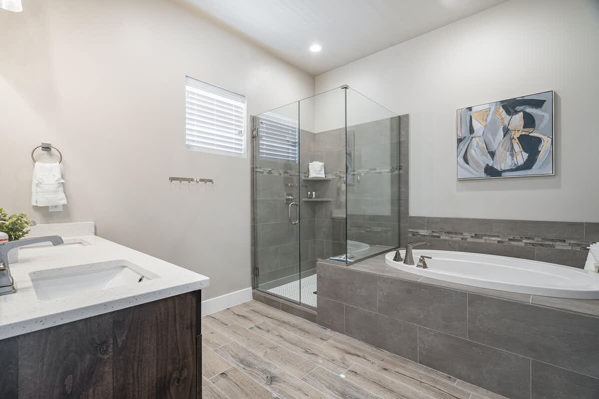 House #51 master bathroom with glass shower and tub