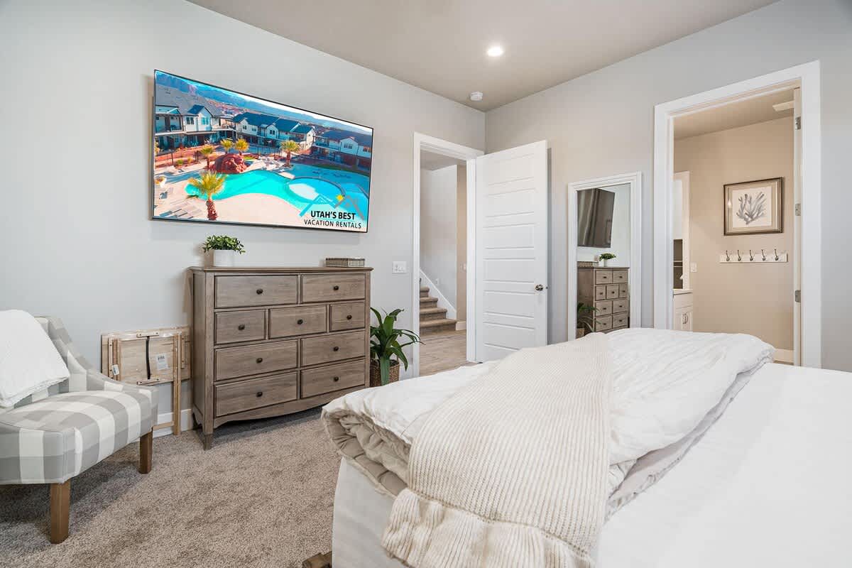 Master bedroom with king bed, dresser and TV
