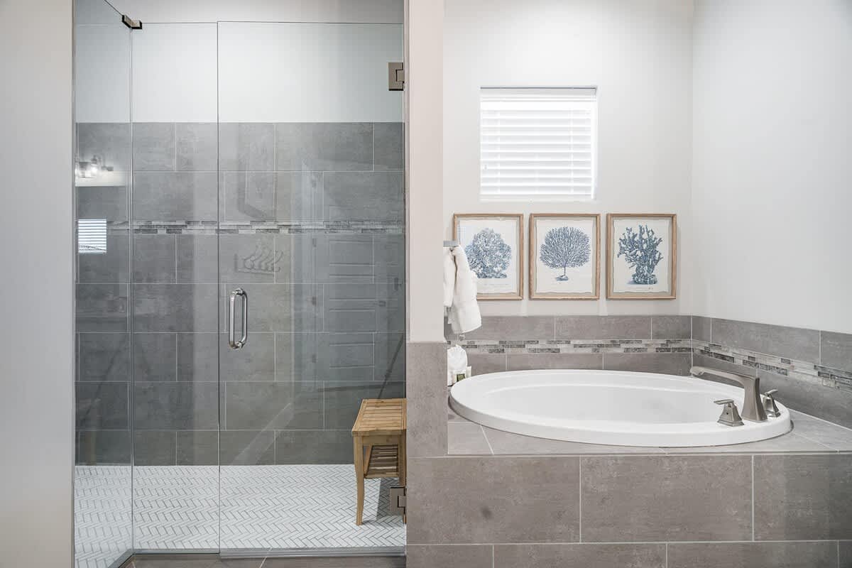 Master bathroom with glass shower and tub