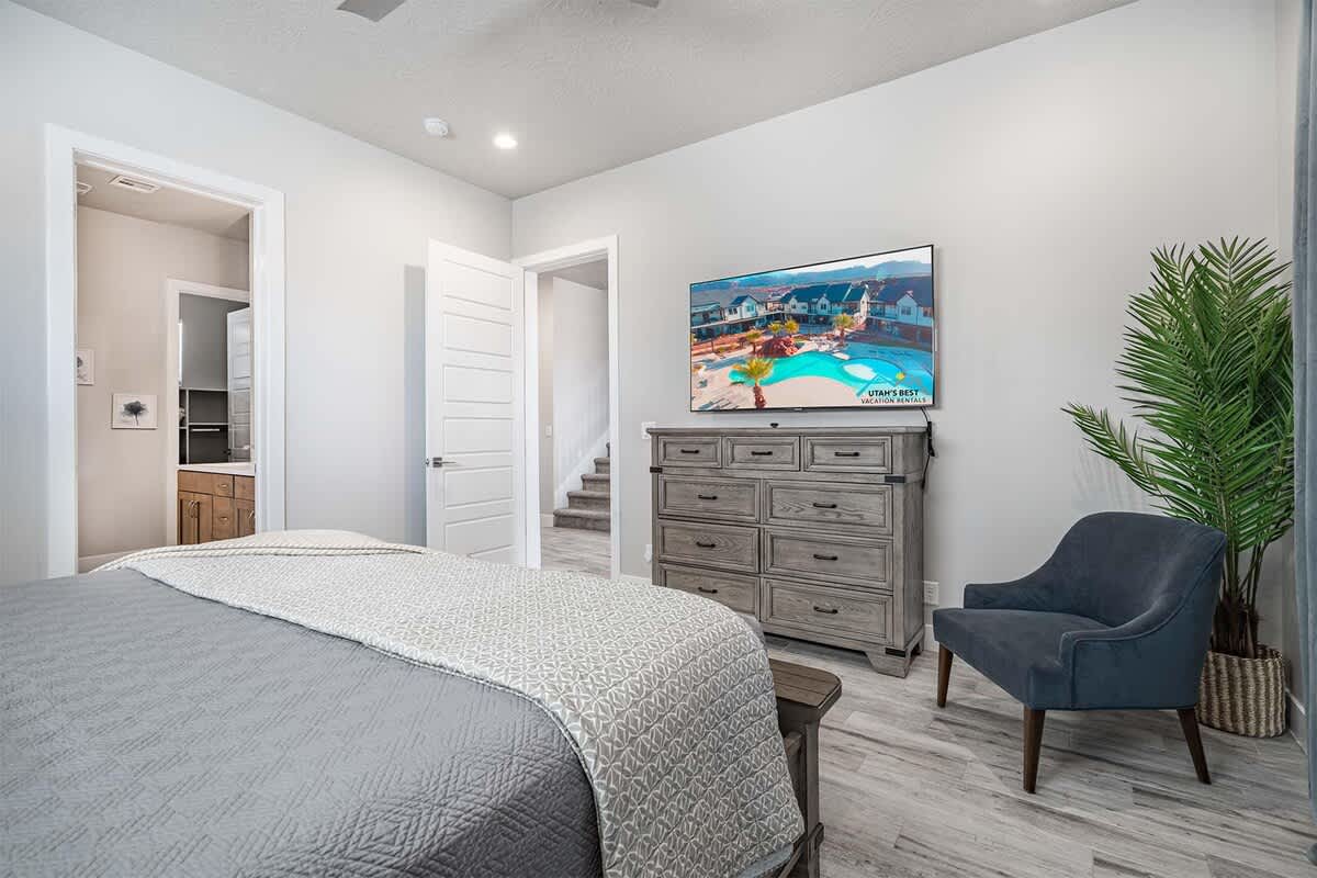 Master bedroom with chair and TV