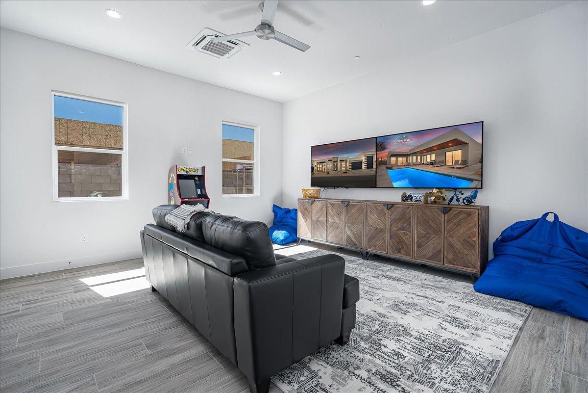 Fun entertainment room with arcade and 2 large TVs & game consol