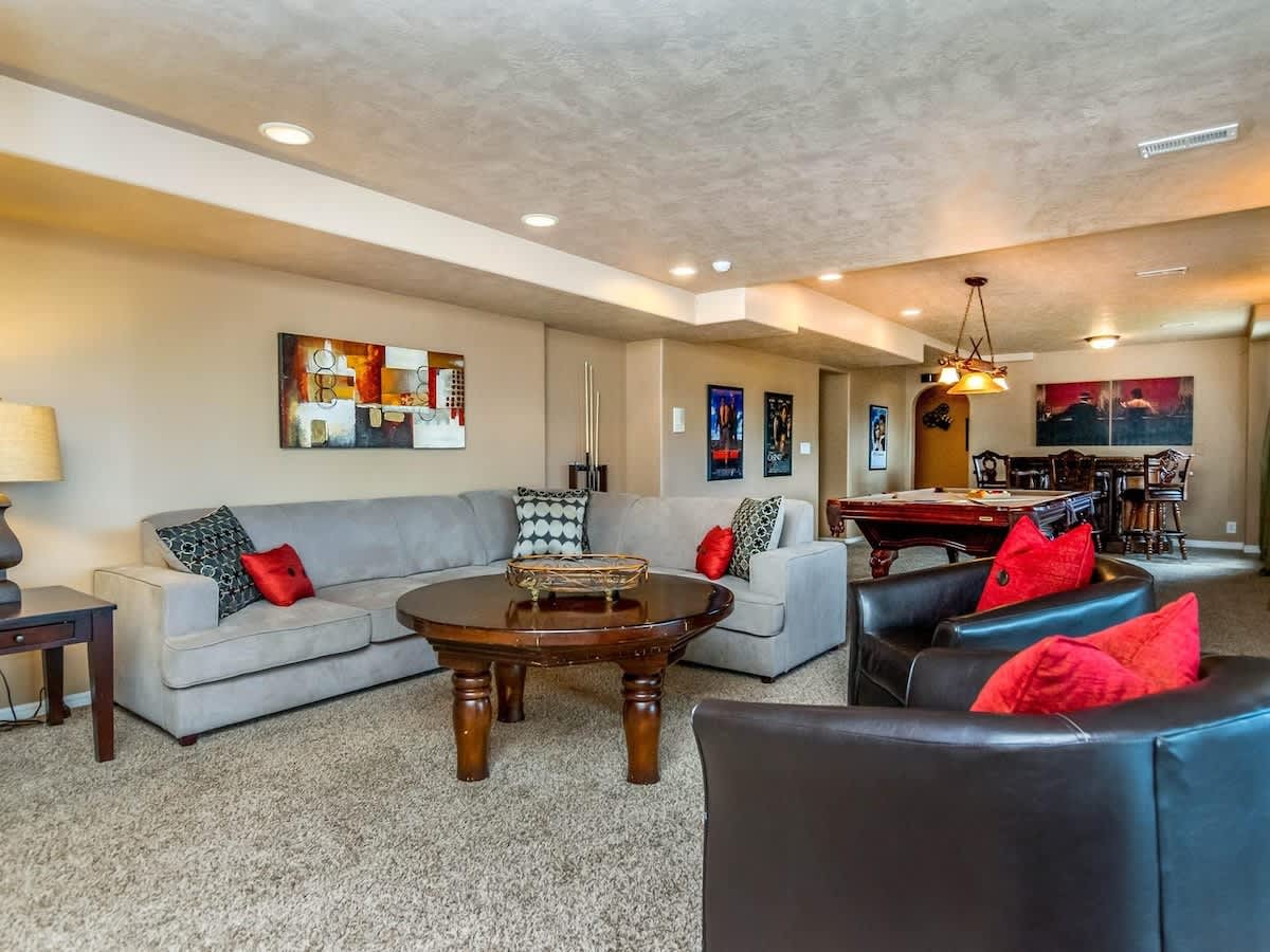 Basement recreation room and lounge area with games and large so
