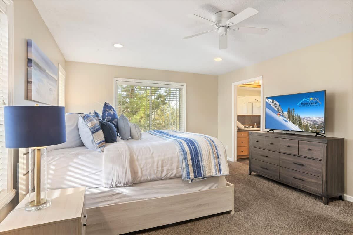 House 1 master bedroom with king bed, TV, dresser