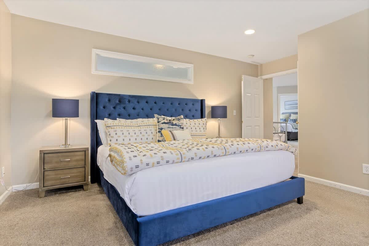 House 2 master bedroom with gorgeous tufted king bed