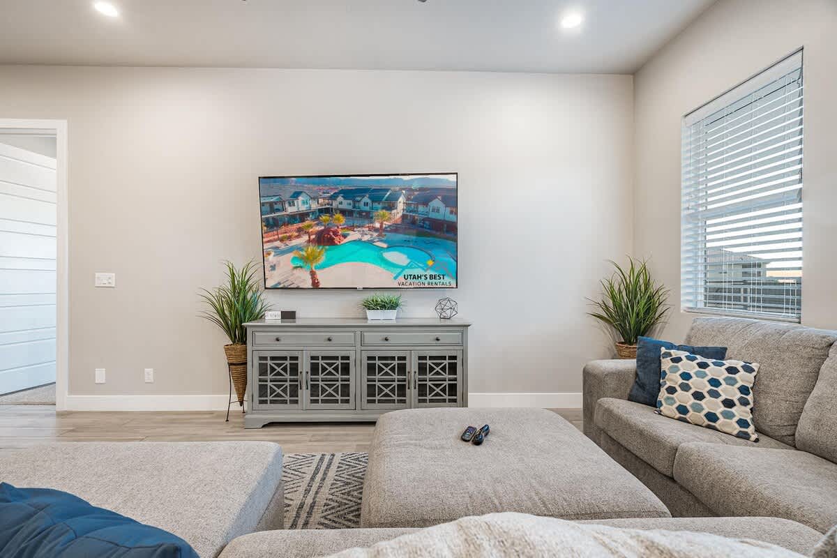 Large living room with lots of seating and large TV