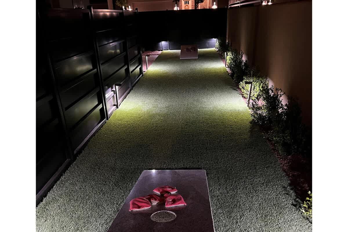 30 - Custom cornhole court nestled on the side of the home