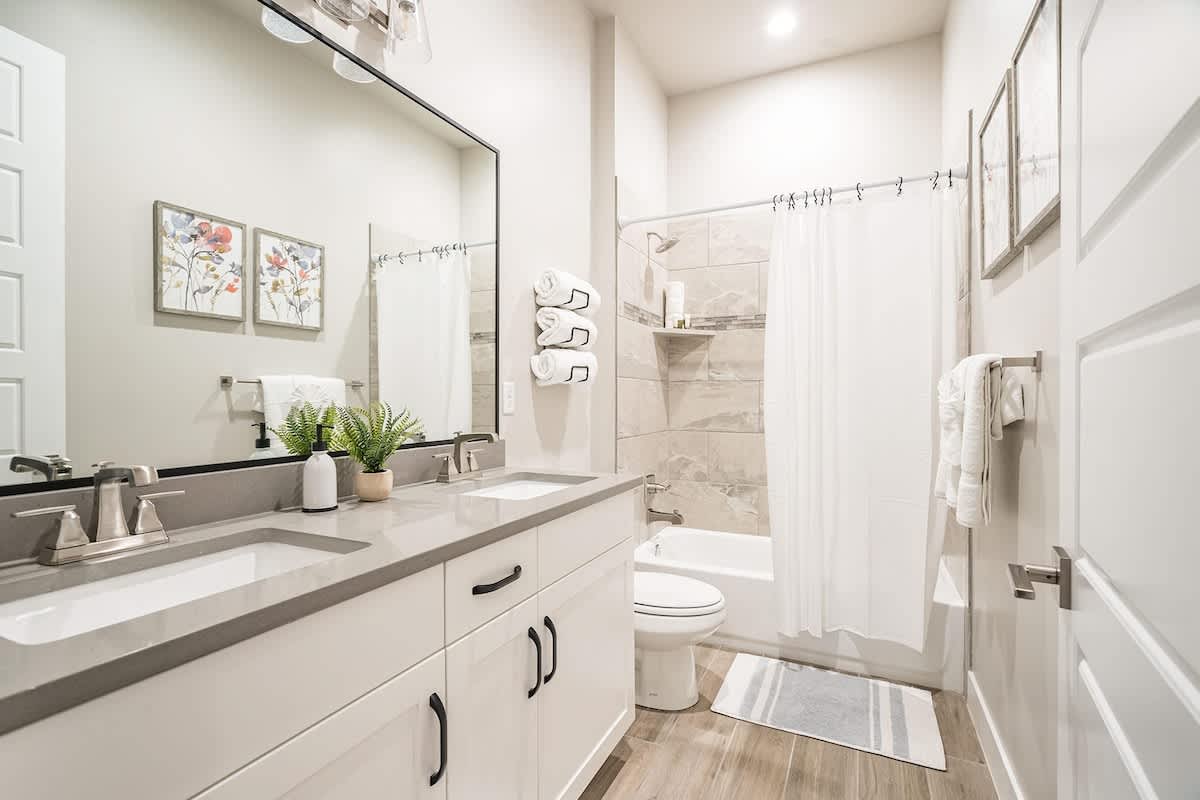 30 - Bathroom 3 with dual sinks and tub/shower combo