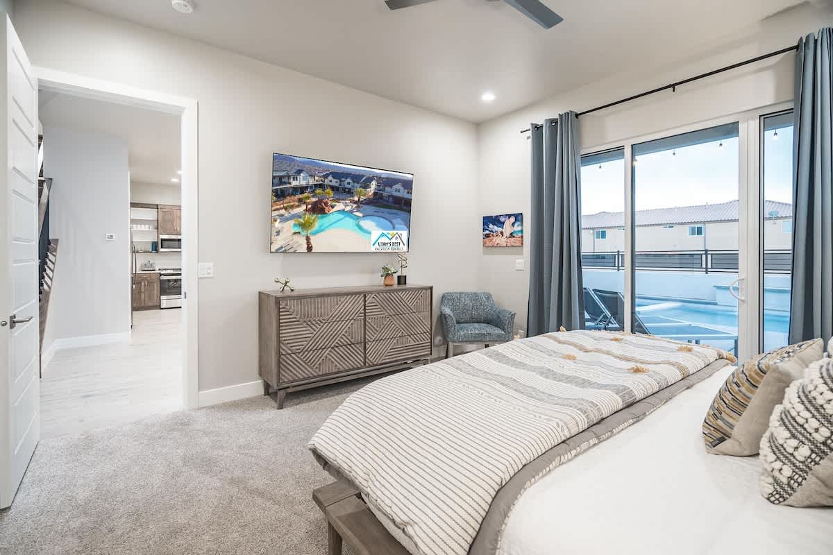 #53 - Master bedroom on main floor with king bed and pool access
