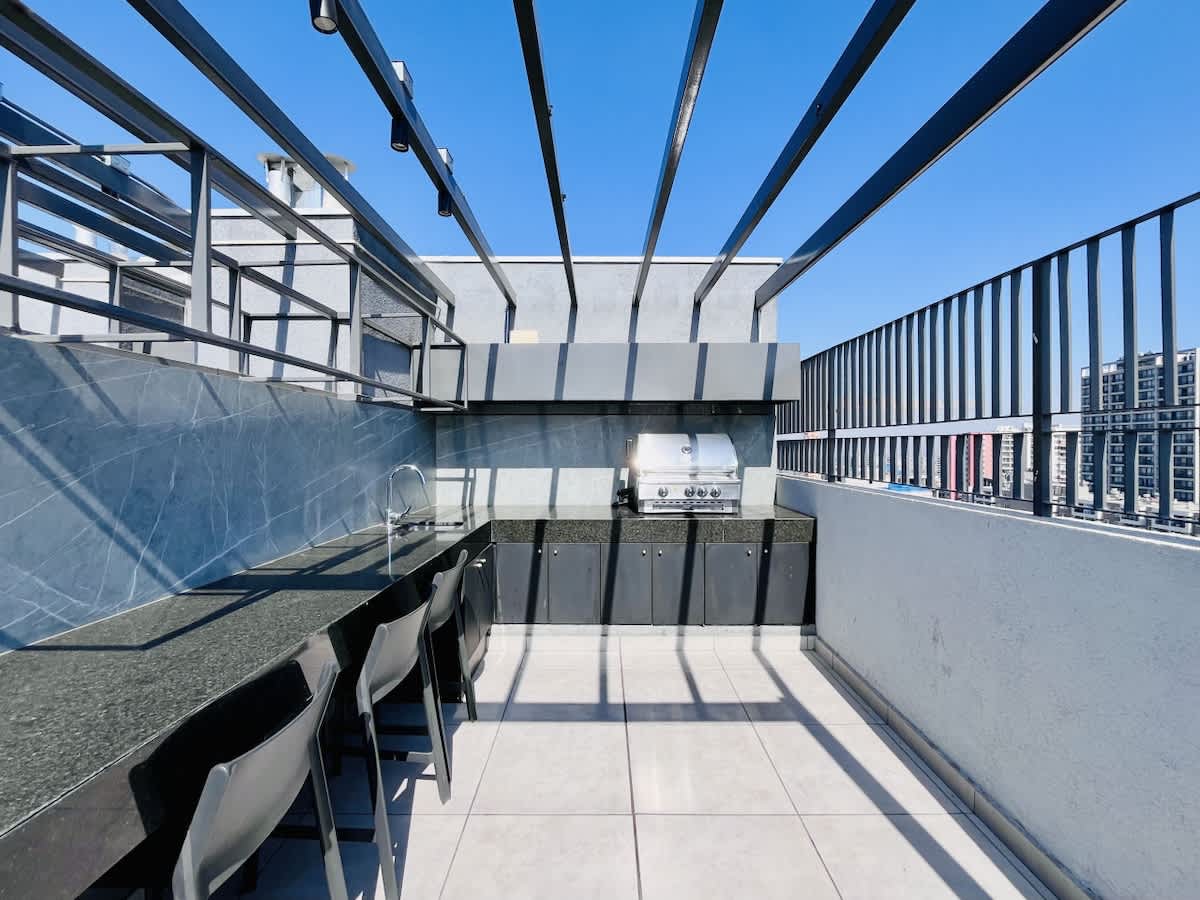 Elevated rooftop terrace w/ seating & sweeping city views