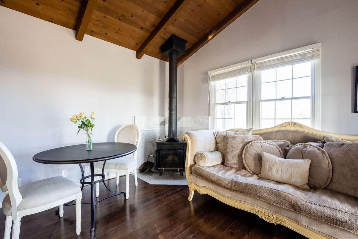 Bright and inviting workspace with natural light, vaulted ceilings, and a wood-burning stove. Ideal for remote work, creative projects, or relaxing with coffee between wine country adventures.