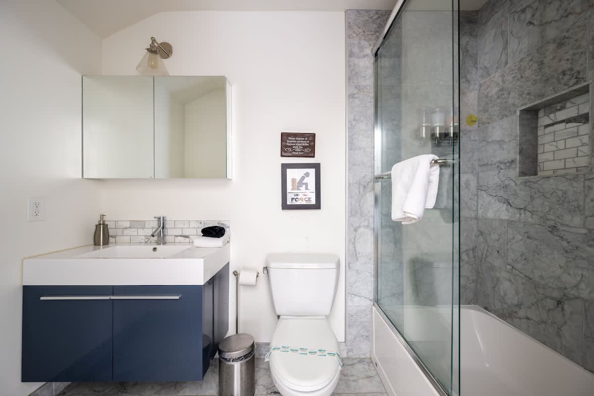 Modern full bathroom with a sleek vanity, walk-in glass shower, and stocked essentials. Perfect for families, retreat guests, or travelers enjoying wine country and nearby golf courses.