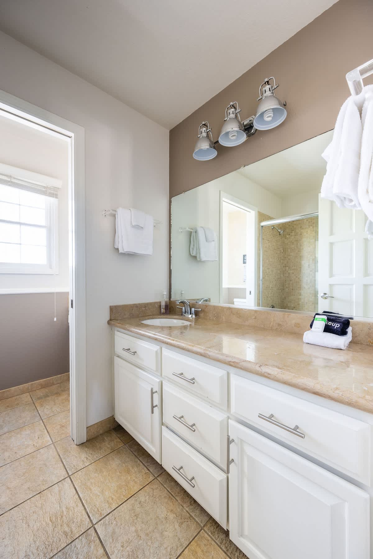 Upstairs private bathroom with a spacious vanity, walk-in shower, and fresh towels. Designed for comfort and convenience, directly en-suite to the Shoreditch Bedroom.