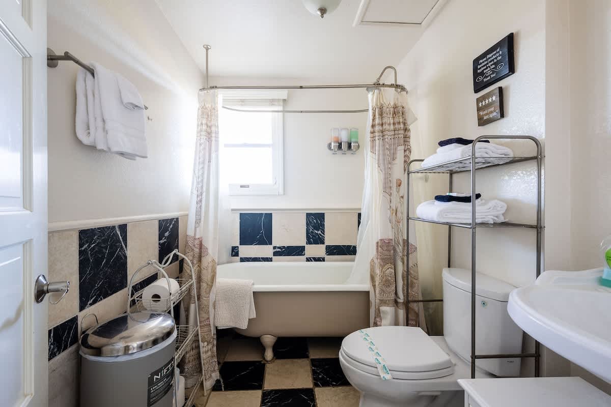 Convenient downstairs bathroom with a full bathtub and shower combo, located near the Bricklane Bedroom. Ideal for families with kids or guests who enjoy a relaxing soak. Stocked with fresh towels, shampoo, conditioner, and body wash.