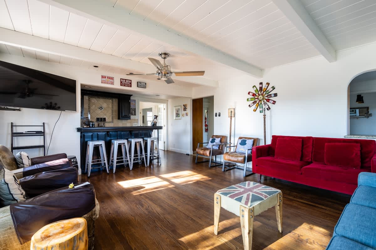 Spacious living room with vibrant seating, bar stools, and plenty of natural light—perfect for relaxing, entertaining, or gathering after a day exploring wine country