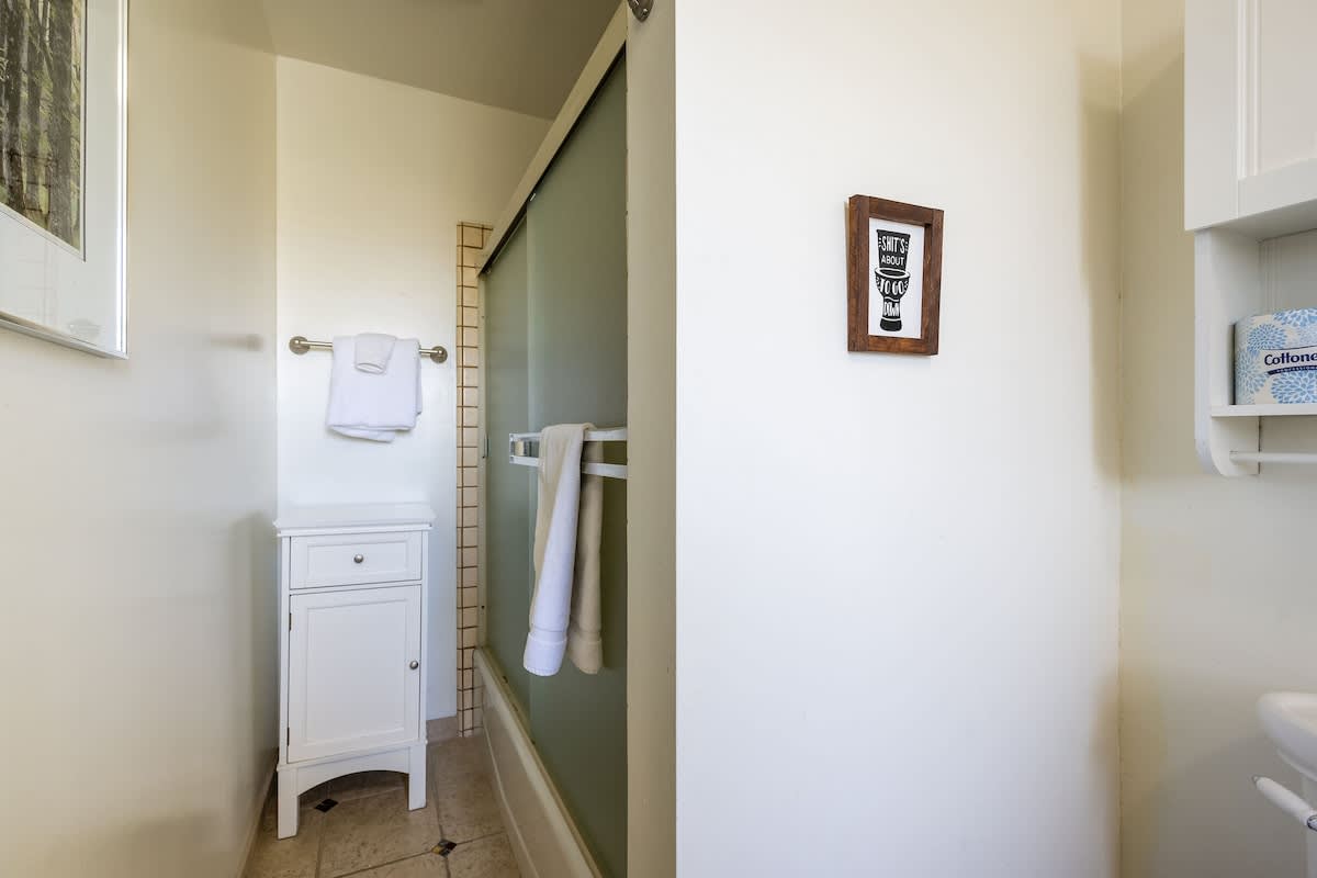 Private upstairs bathroom featuring a walk-in shower and fresh linens, exclusively for guests in the Hampstead Bedroom