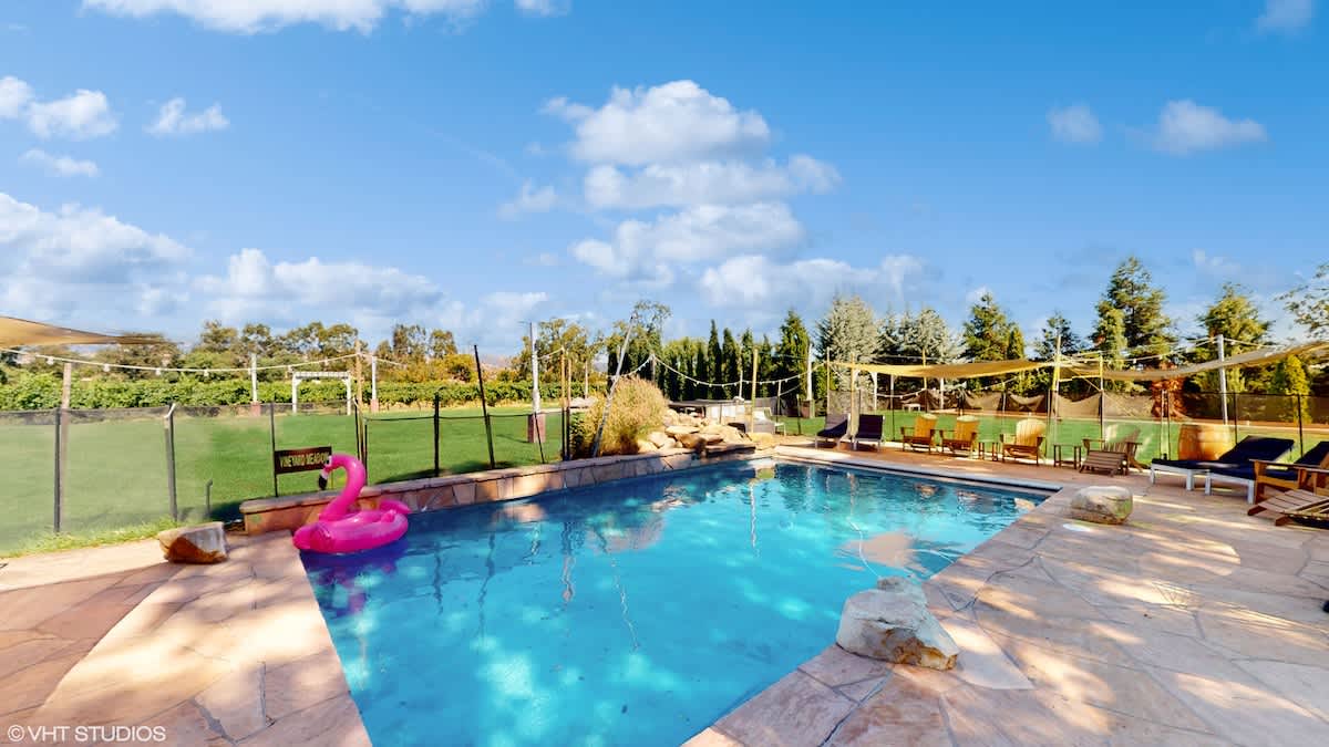 Kids will love splashing in the pool while parents relax under the shade sails. A safe, fun space for family vacations with plenty of seating and sunny vineyard views.