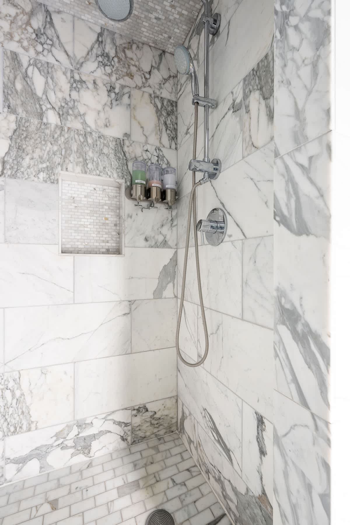 Luxury marble walk-in shower with rainfall & handheld options, stocked with shampoo, conditioner & body wash. Refresh after wine tasting, golf, or corporate retreats in San Martin, Gilroy & Morgan Hill.