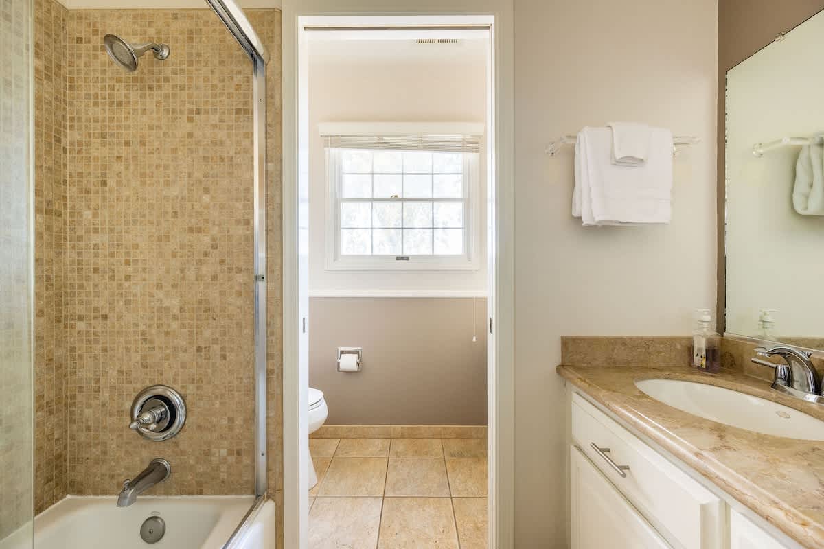 Private upstairs bathroom with a tub/shower combo, spacious vanity, and natural light. Conveniently en-suite to the Shoreditch Bedroom for comfort and privacy.
