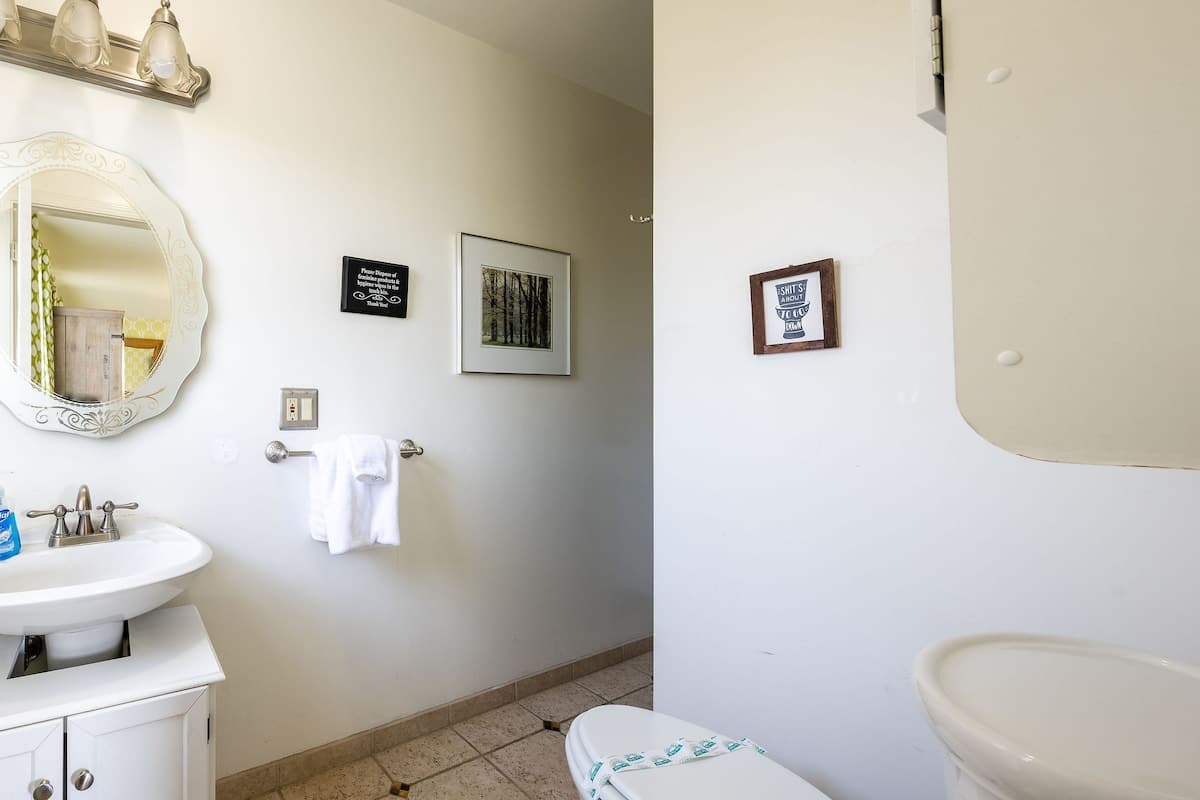 Private upstairs bathroom featuring a walk-in shower and fresh linens, exclusively for guests in the Hampstead Bedroom.