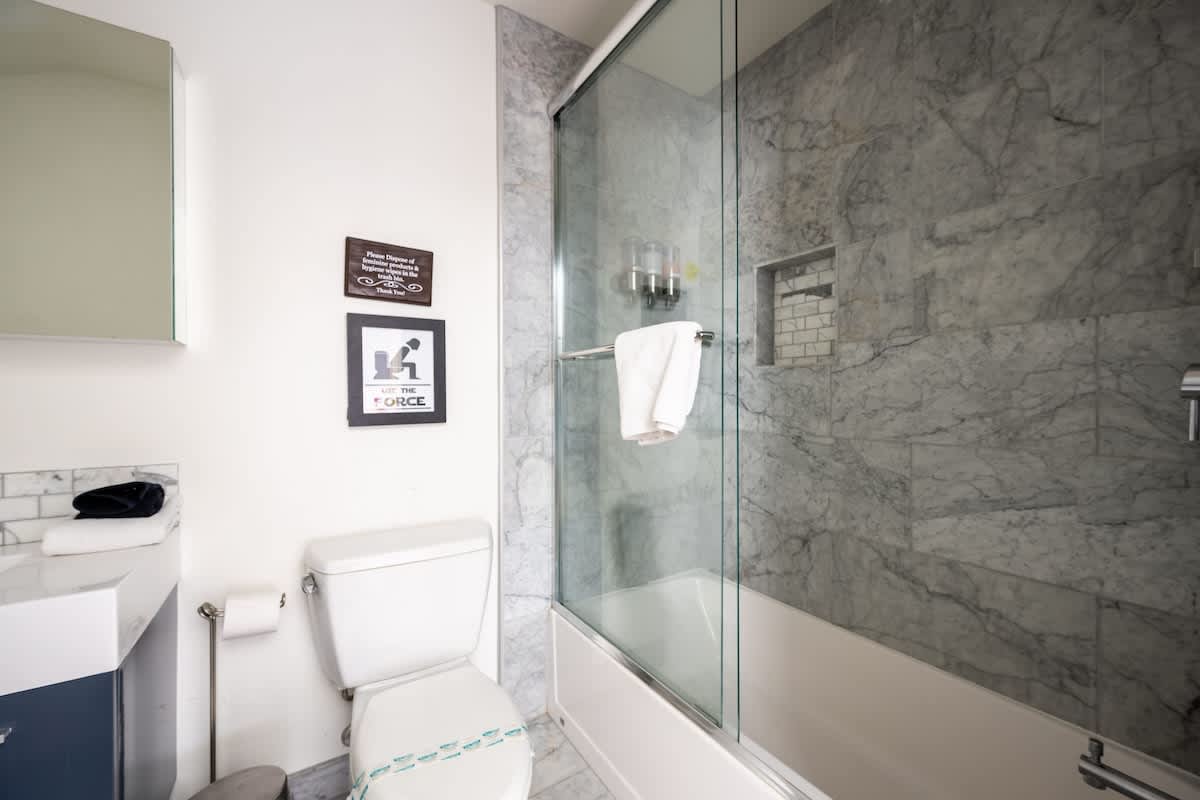 Modern bathroom with a tub and shower combo, sleek finishes, and full amenities. Perfect for families, wine lovers, golfers, or corporate retreat guests seeking both relaxation and convenience.