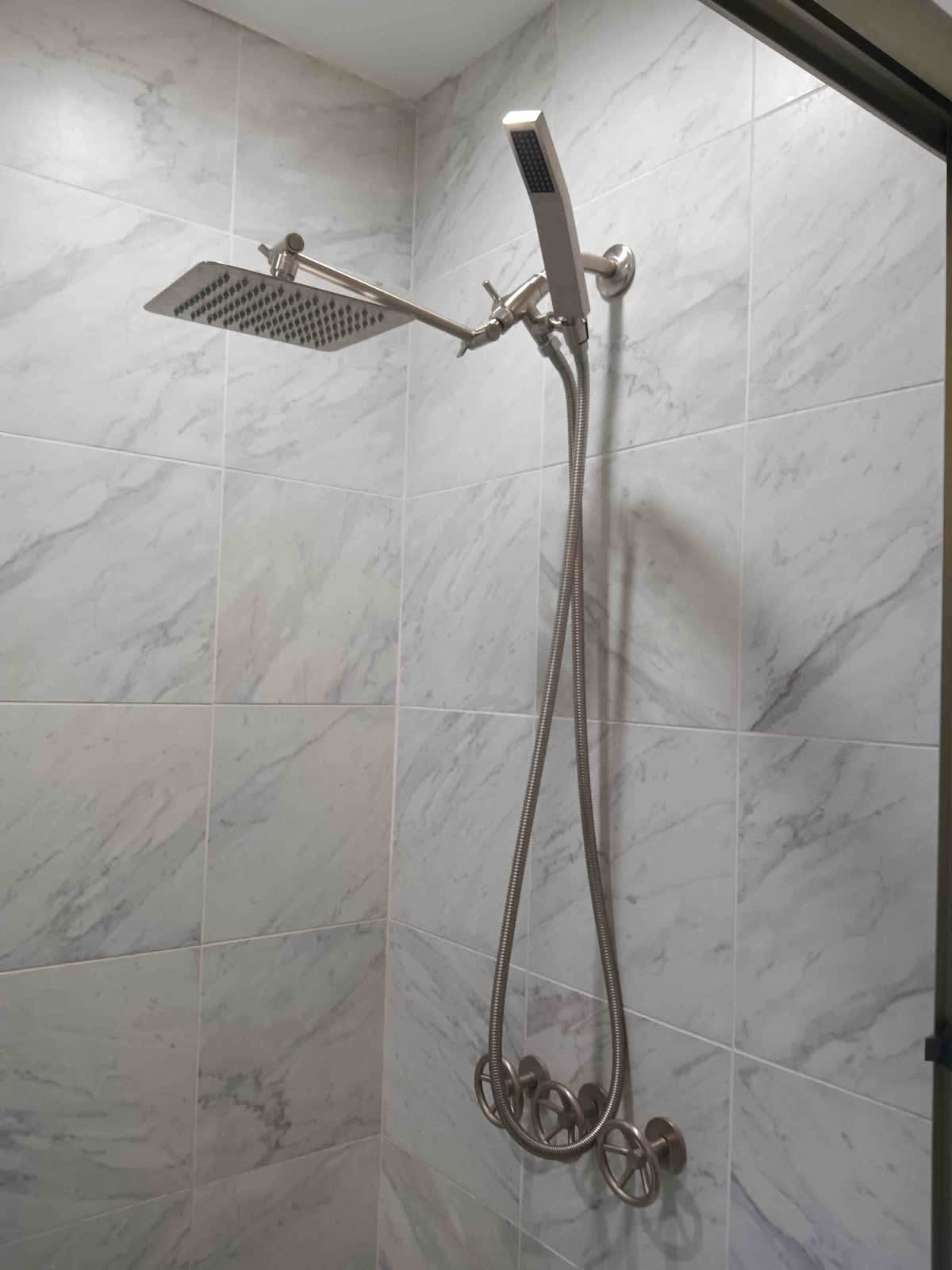 Relax in the modern tub and enjoy the rainfall + handheld shower for the perfect spa-like experience.