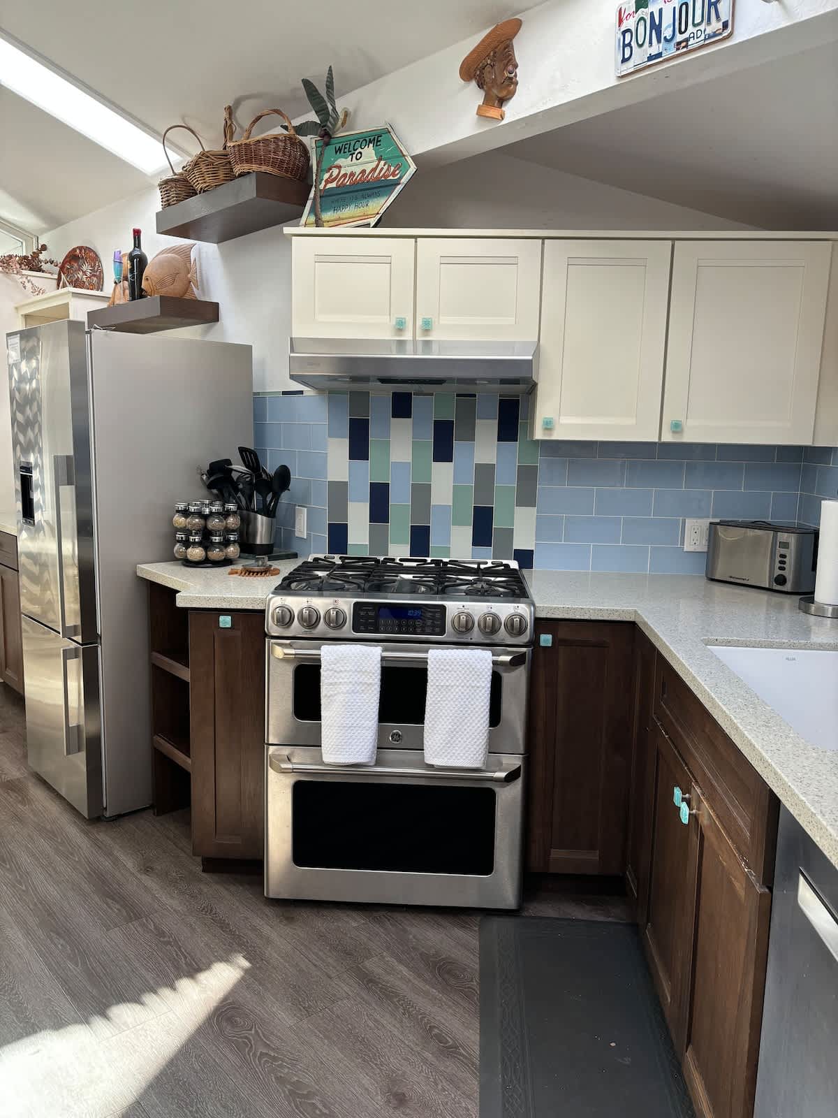 Cook with ease in this modern kitchen featuring a gas stove, dishwasher, and plenty of counter space—perfect for family meals, a romantic dinner for two, or a quick meal before business meetings.