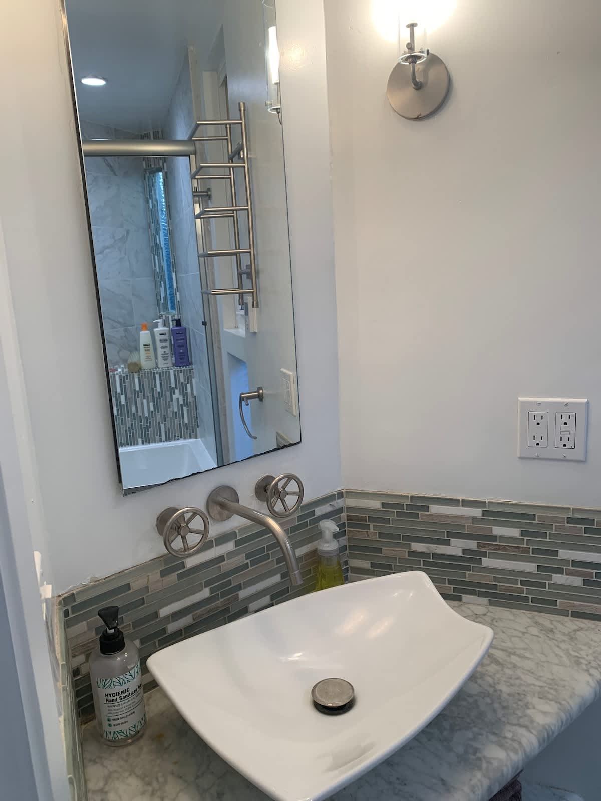 Modern bathroom with sleek vessel sink, marble countertop, and stylish backsplash—perfect for freshening up after a day of wine tasting or outdoor fun.