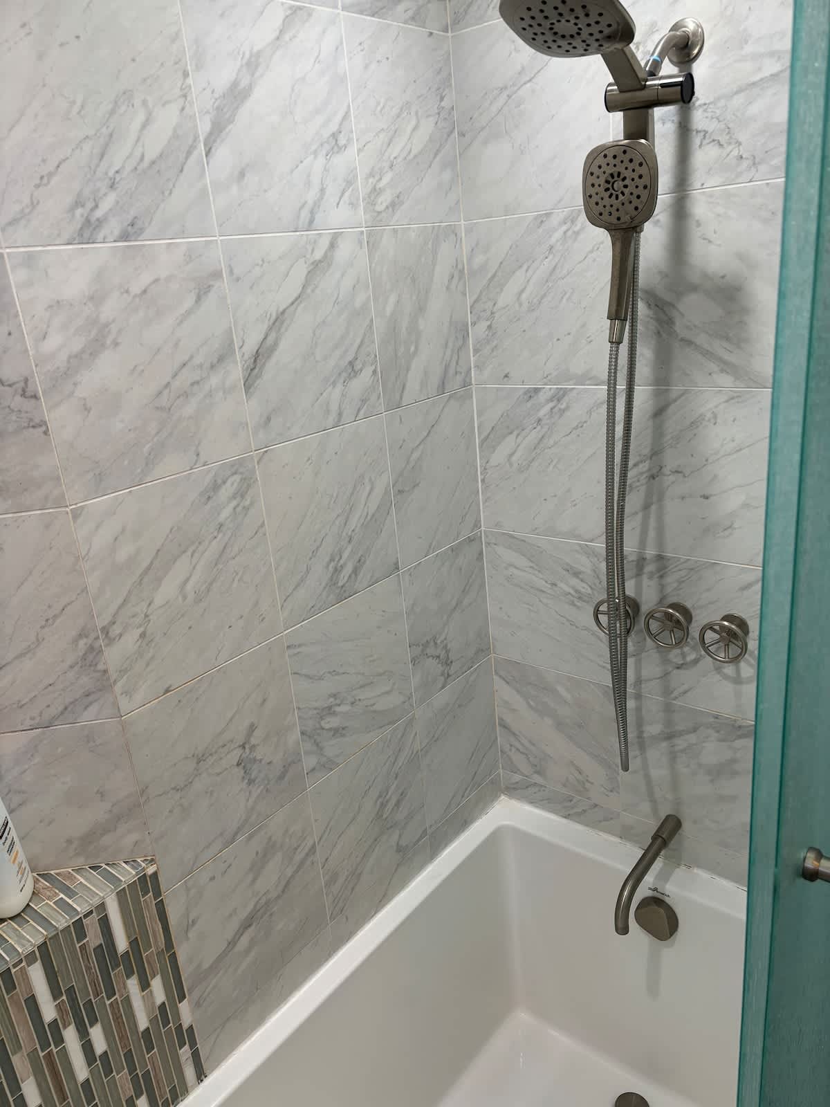 Elegant marble-tiled bath with dual shower heads and a soaking tub—perfect for both quick rinses and long, relaxing soaks.