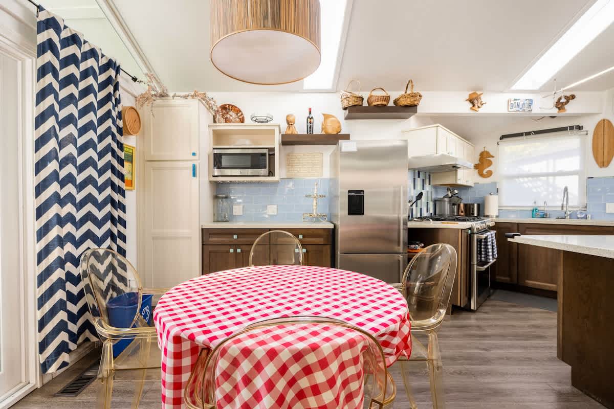 Bright and inviting dining area with a classic round table, modern chairs, and easy access to the kitchen—perfect for family meals or casual gatherings.