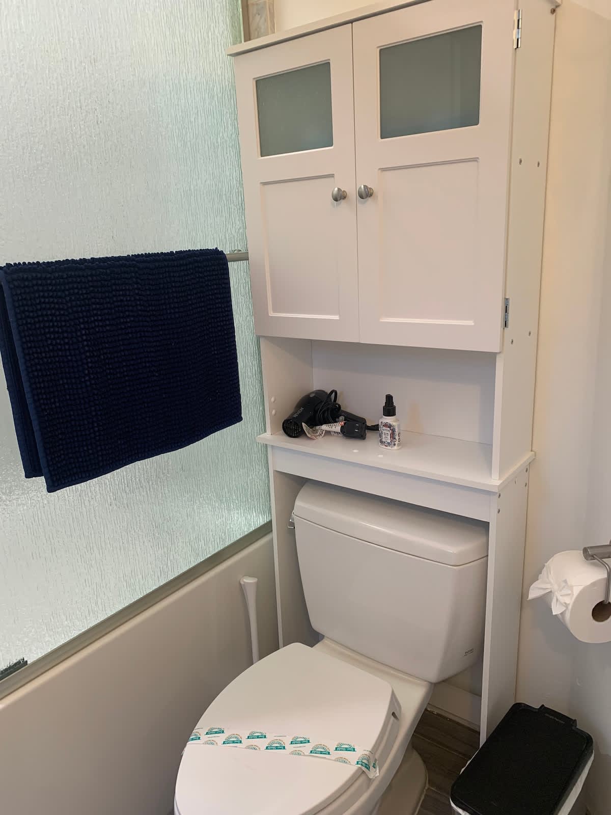 Full bathroom with modern storage, fresh linens, and essential toiletries provided—thoughtfully stocked so you can settle in and feel at home.