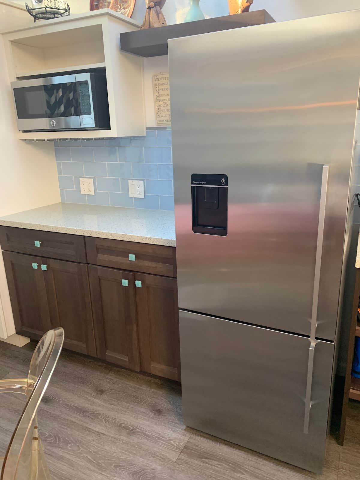 Fully stocked kitchenette with modern fridge, microwave, and plenty of counter space—perfect for preparing snacks, light meals, or morning coffee before heading out.