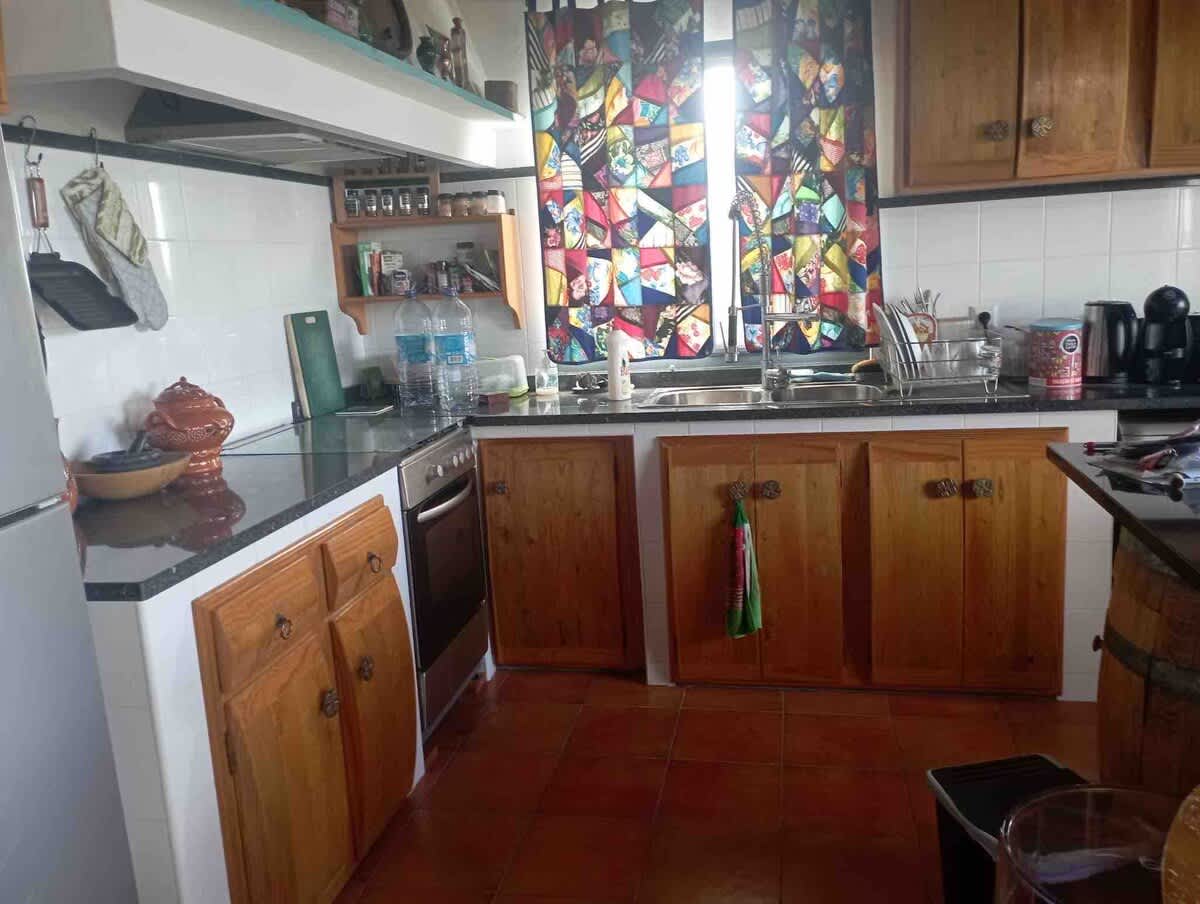 The kitchen cabinets are made from my fathers wine barrels.
Patchwork curtains made from my moms clothes.
