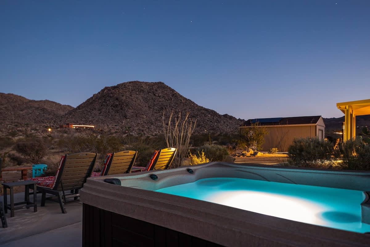 Soak in the hot tub overlooking the beautiful desert mountain views