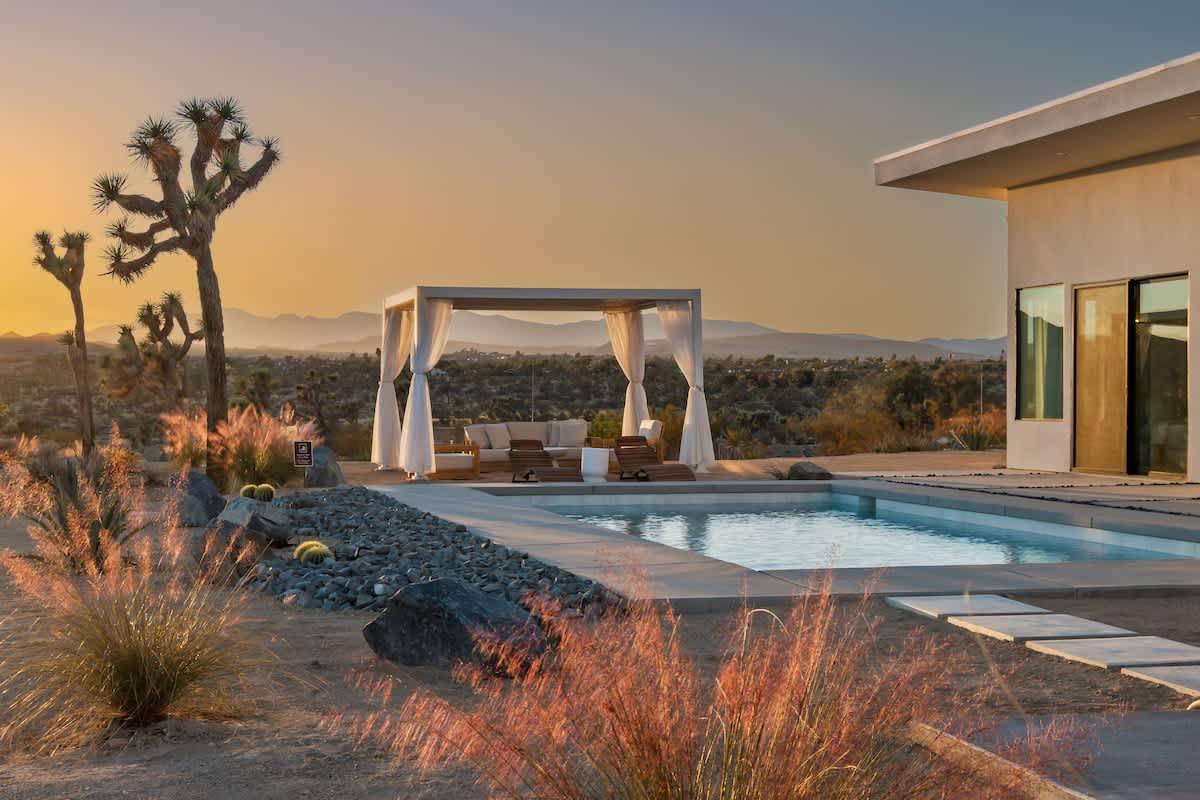 Backyard oasis during sunset with desert and mountain views 