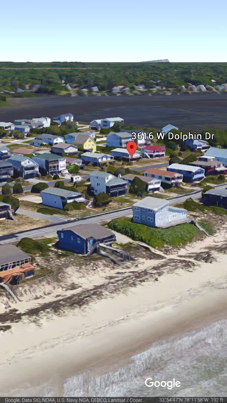 Public beach access is between the houses in the middle of the image.