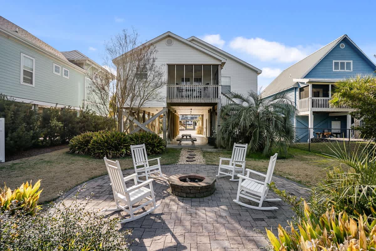 Private backyard courtyard featuring a fire pit and comfortable seating—ideal for relaxing evenings, or winding down after a day at the beach.”