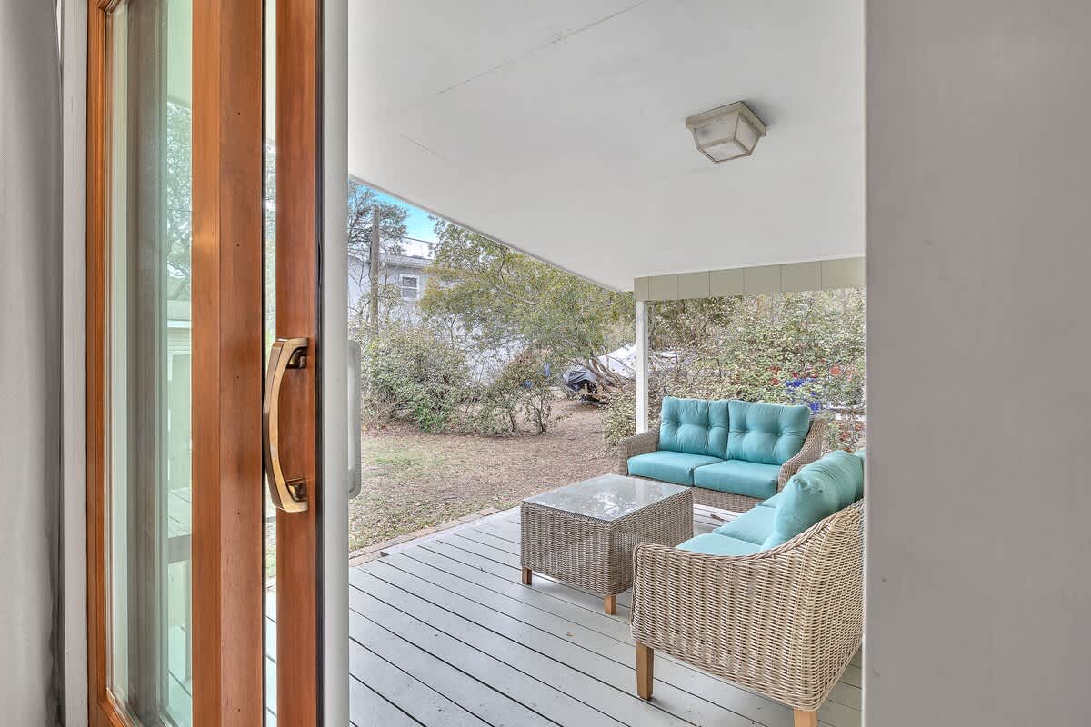 Sliding doors from the dining area take you to the private covered porch at the back of the house