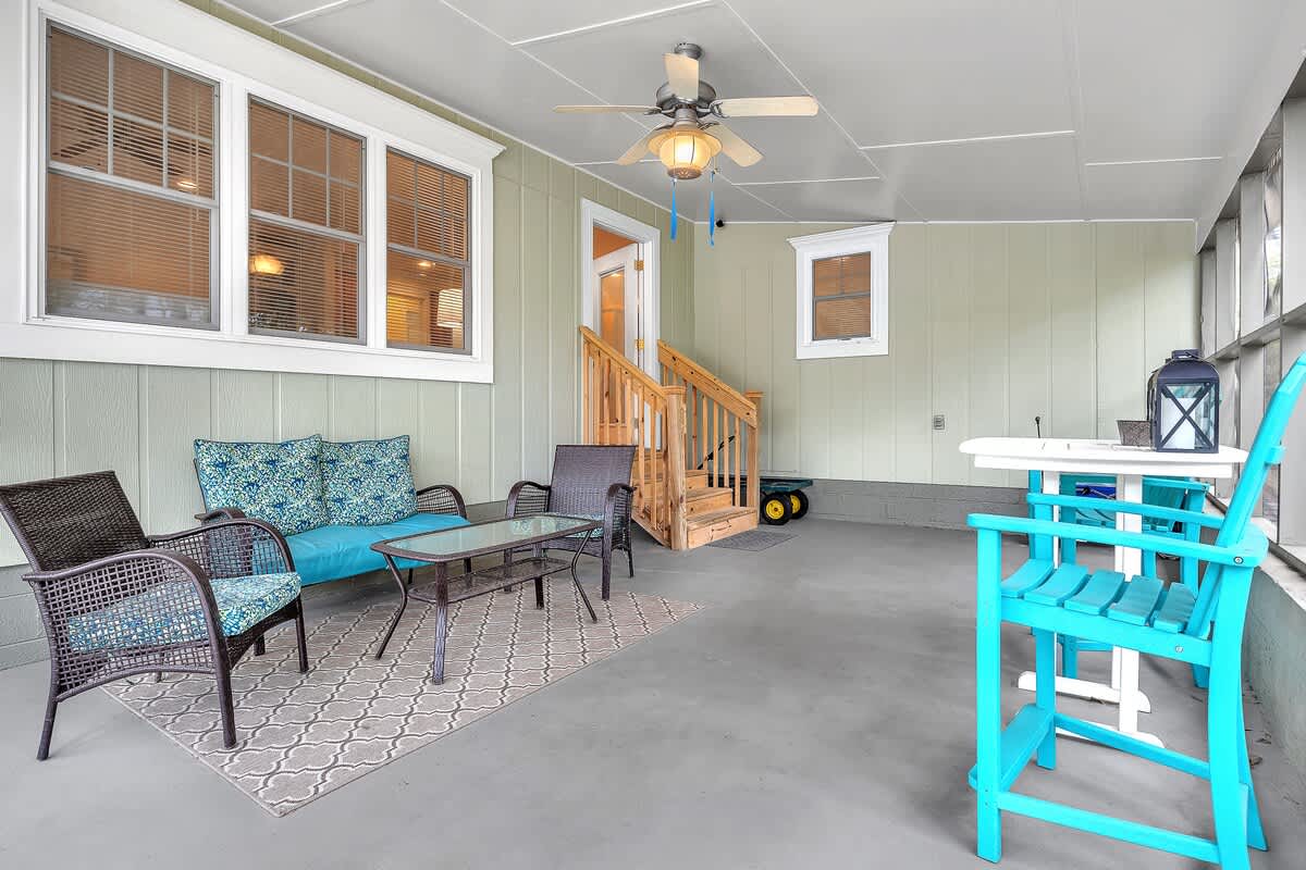Screened porch has plenty of lounge space and storage for beach toys
