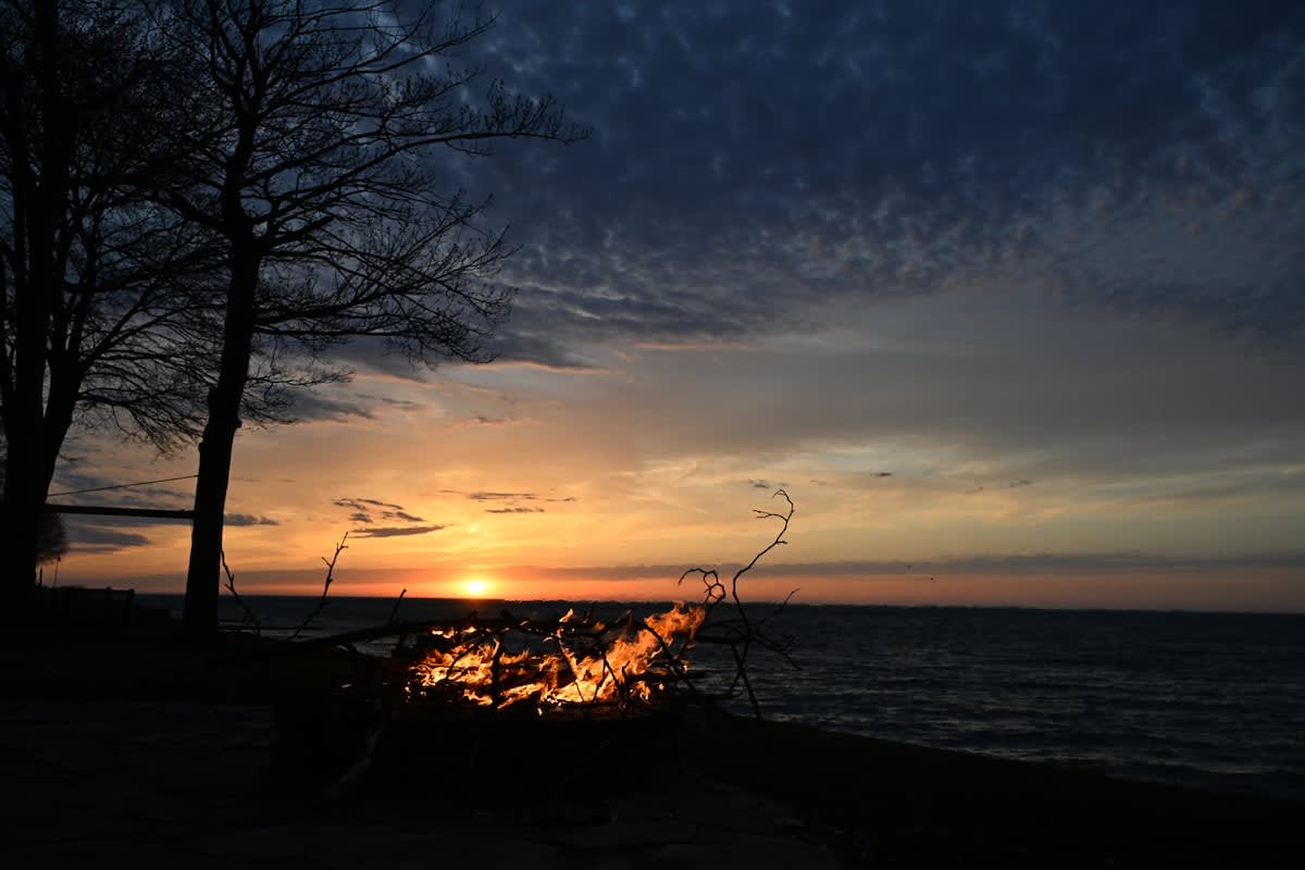 Sunsets on the water with a sweater-weather fire 