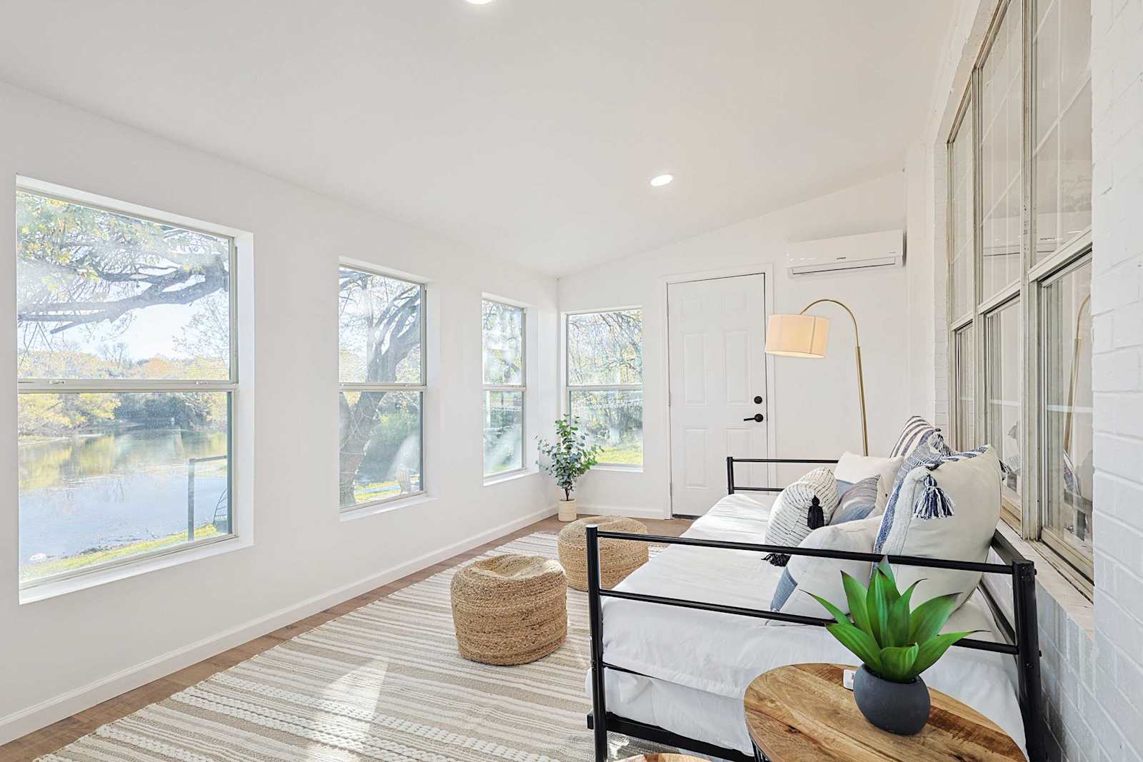 Sunlit lakeside sunroom at McGraw Lakeside Villa