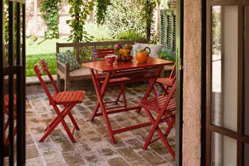 Red outdoor table and chairs on a terrace