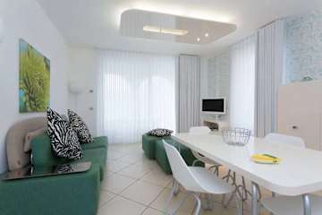 Green sofa and white dining table